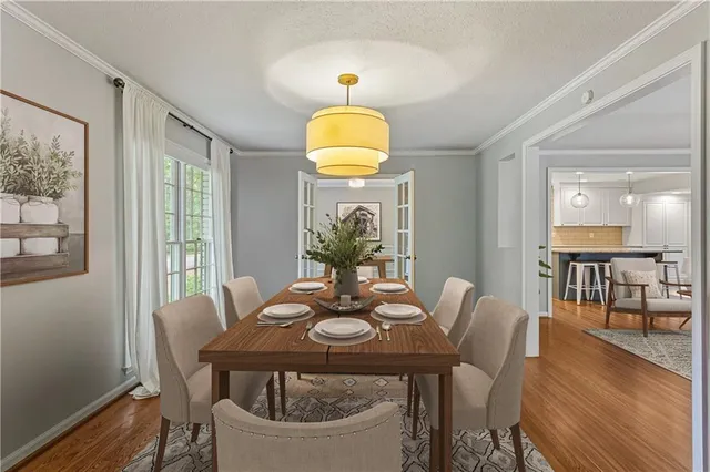 a view of a dining room with furniture window and wooden floor