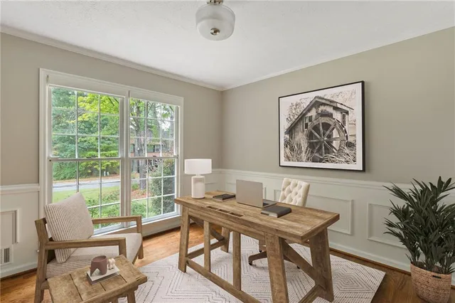 a view of a workspace with furniture and a potted plant