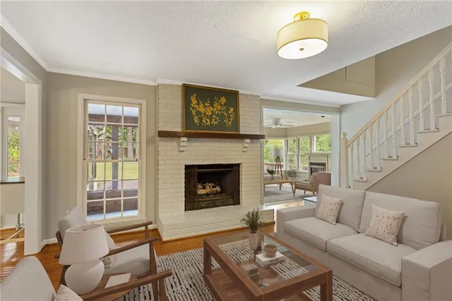 a living room with furniture fireplace and window