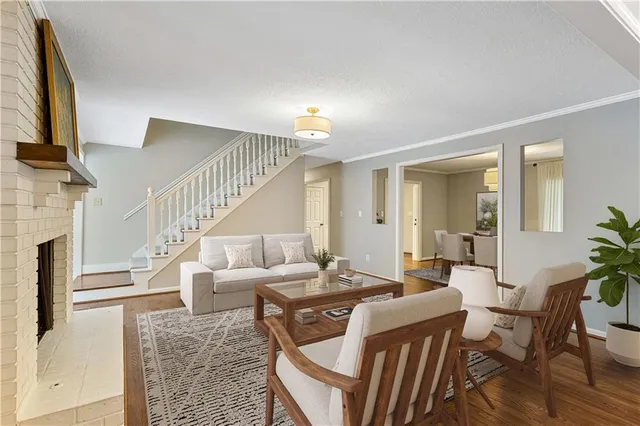 a living room with furniture a fireplace and a flat screen tv