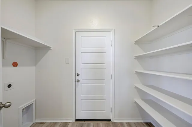 a view of walk in closet with empty racks