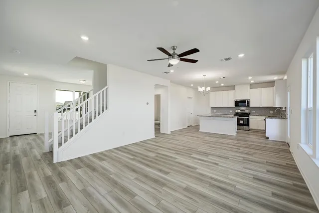 a view of kitchen with refrigerator microwave and wooden floor