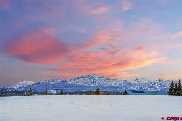a view of a town with mountains in the background