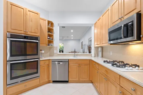 a kitchen with a sink stove and microwave
