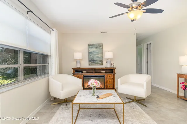 a living room with furniture a rug and a lamp
