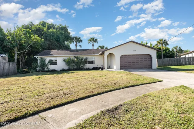 a front view of a multi story building with yard