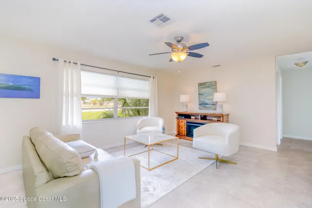 a living room with furniture and a dining table