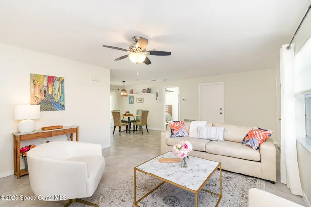 a living room with furniture a rug and a window