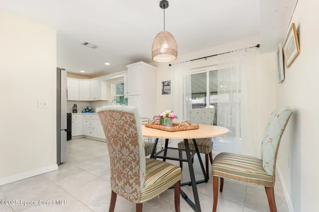 a living room with furniture a window and a chandelier