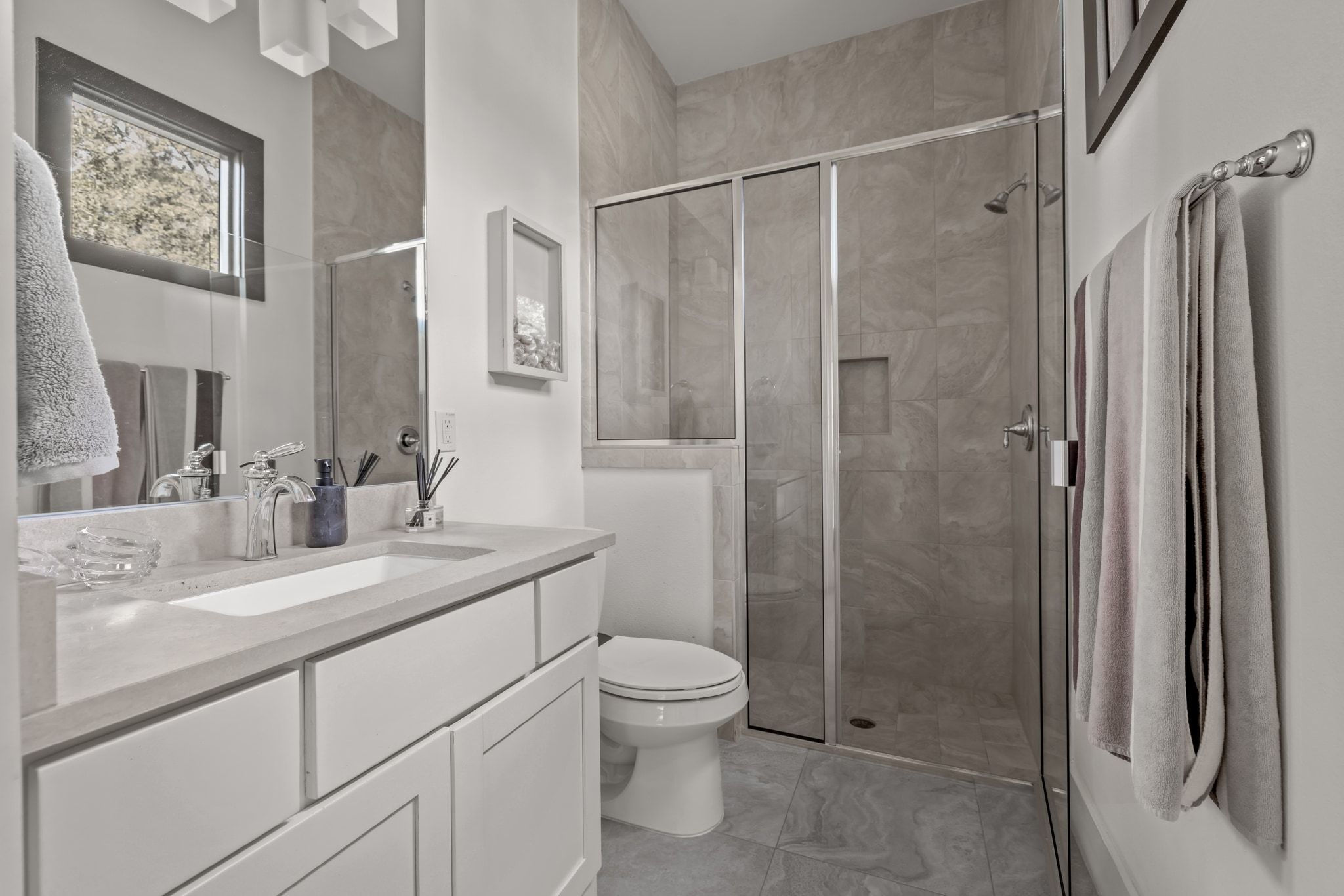 4720 Rockcliff Road, Unit 1 Austin, TX 78746 - Photo 32 of 39 A well-appointed bathroom features a spacious vanity with an undermount sink and a sleek glass-enclosed shower.