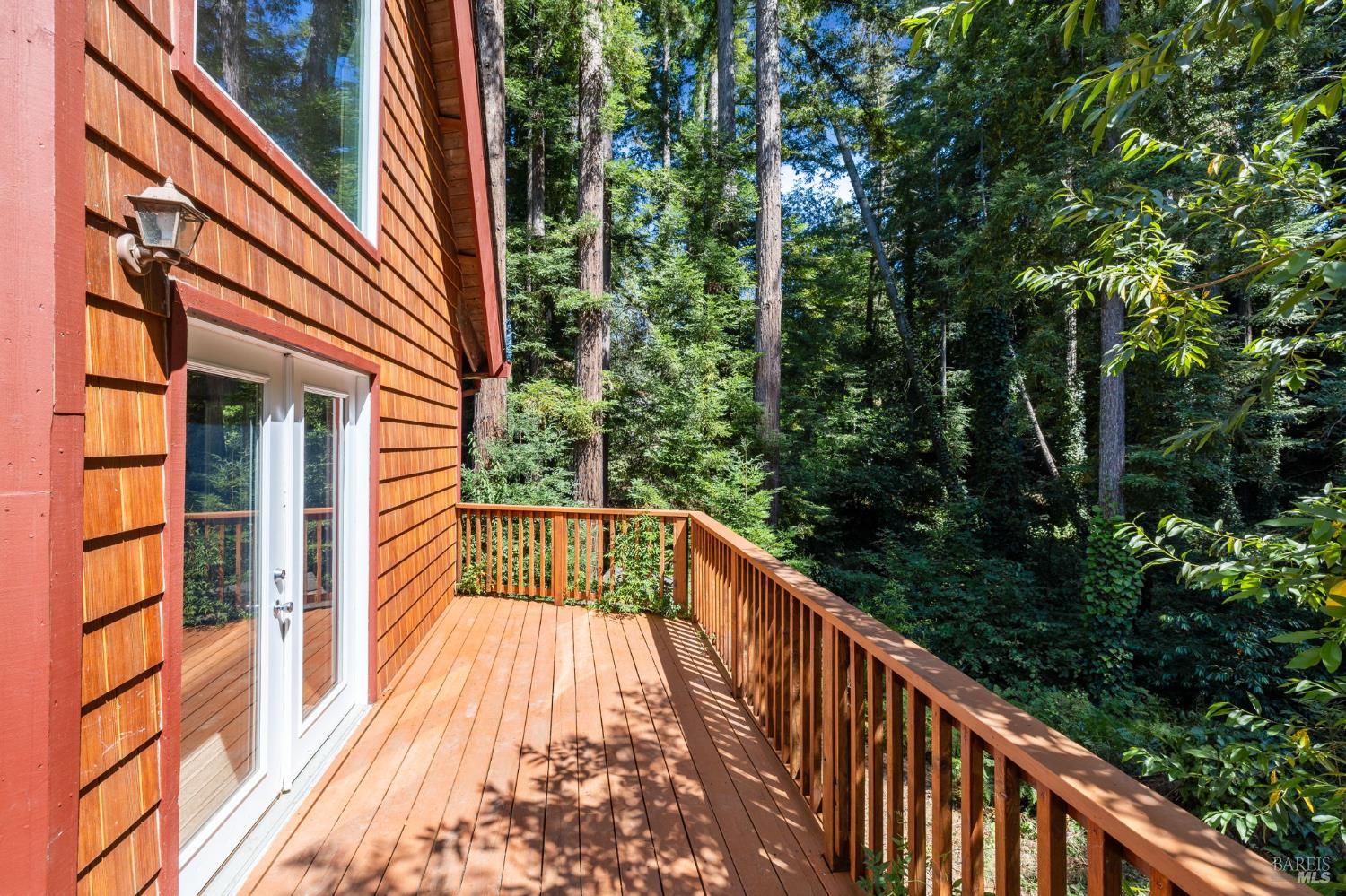 9935 Occidental Road Sebastopol, CA 95472 - Photo 22 of 53 The deck off of the living room, where many forest creatures can be spotted: great horned owls, birds, deer, & more
