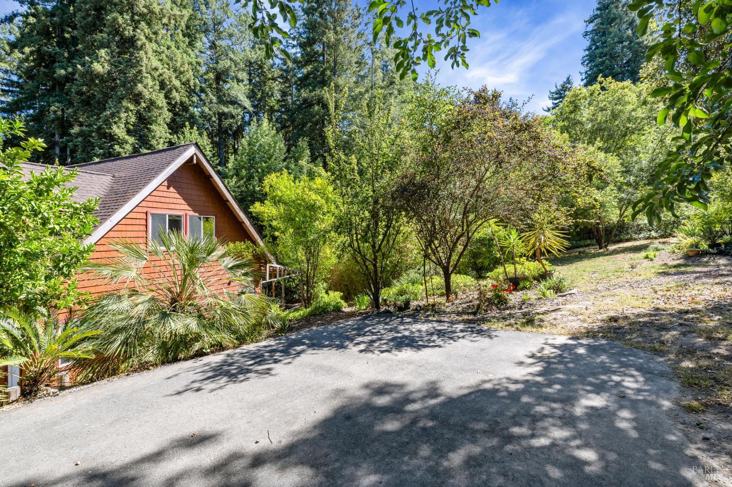 9935 Occidental Road Sebastopol, CA 95472 - Photo 41 of 53 View of the garage/ADU and sunny space, from the upper parking area