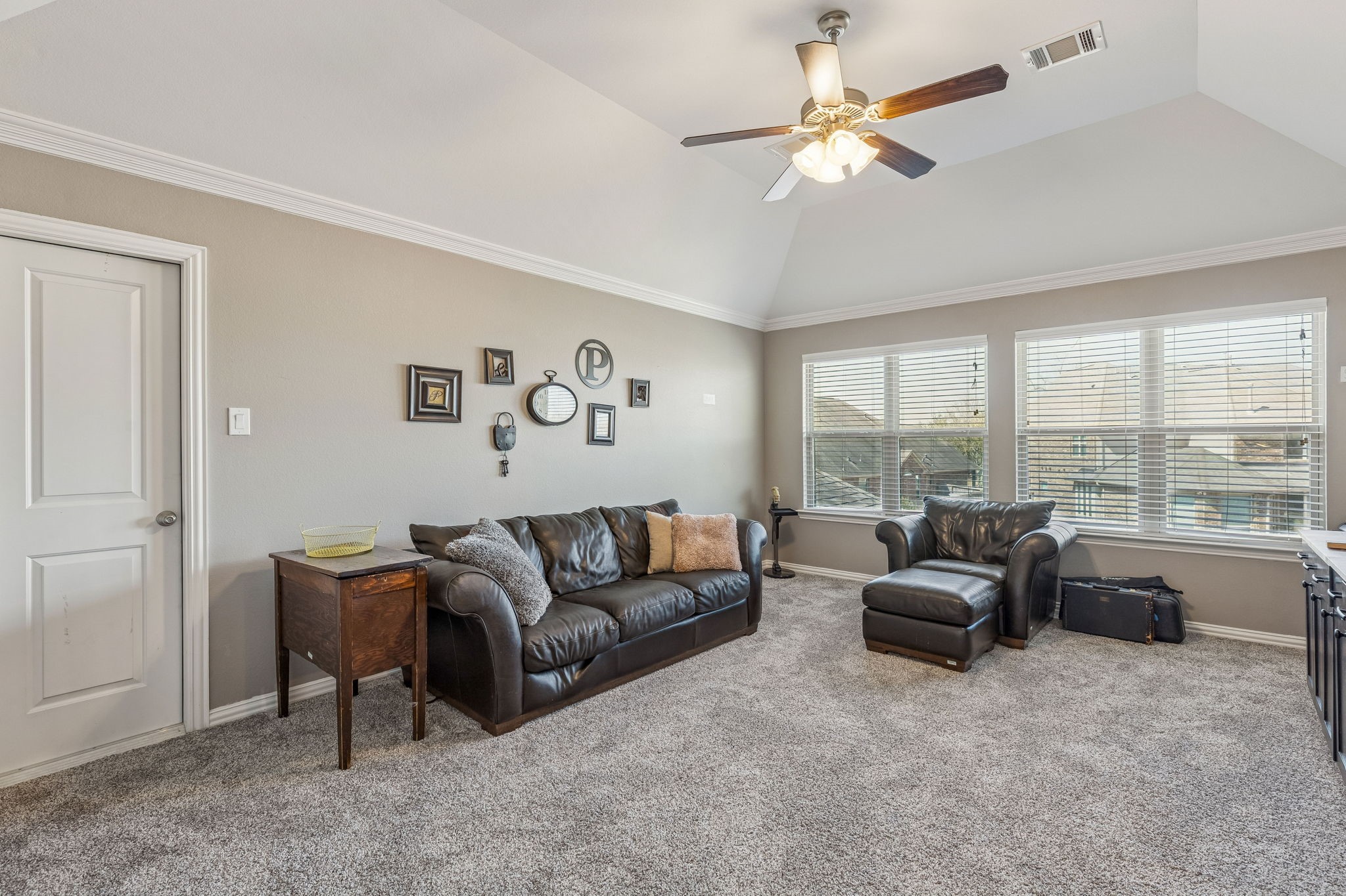 29918 Valley Terrace Drive Fulshear, TX 77406 - Photo 15 of 27 Head upstairs to the large gameroom, a versatile second living area perfect for movie nights or play. This bright space features high ceilings, plush carpeting, and large windows.