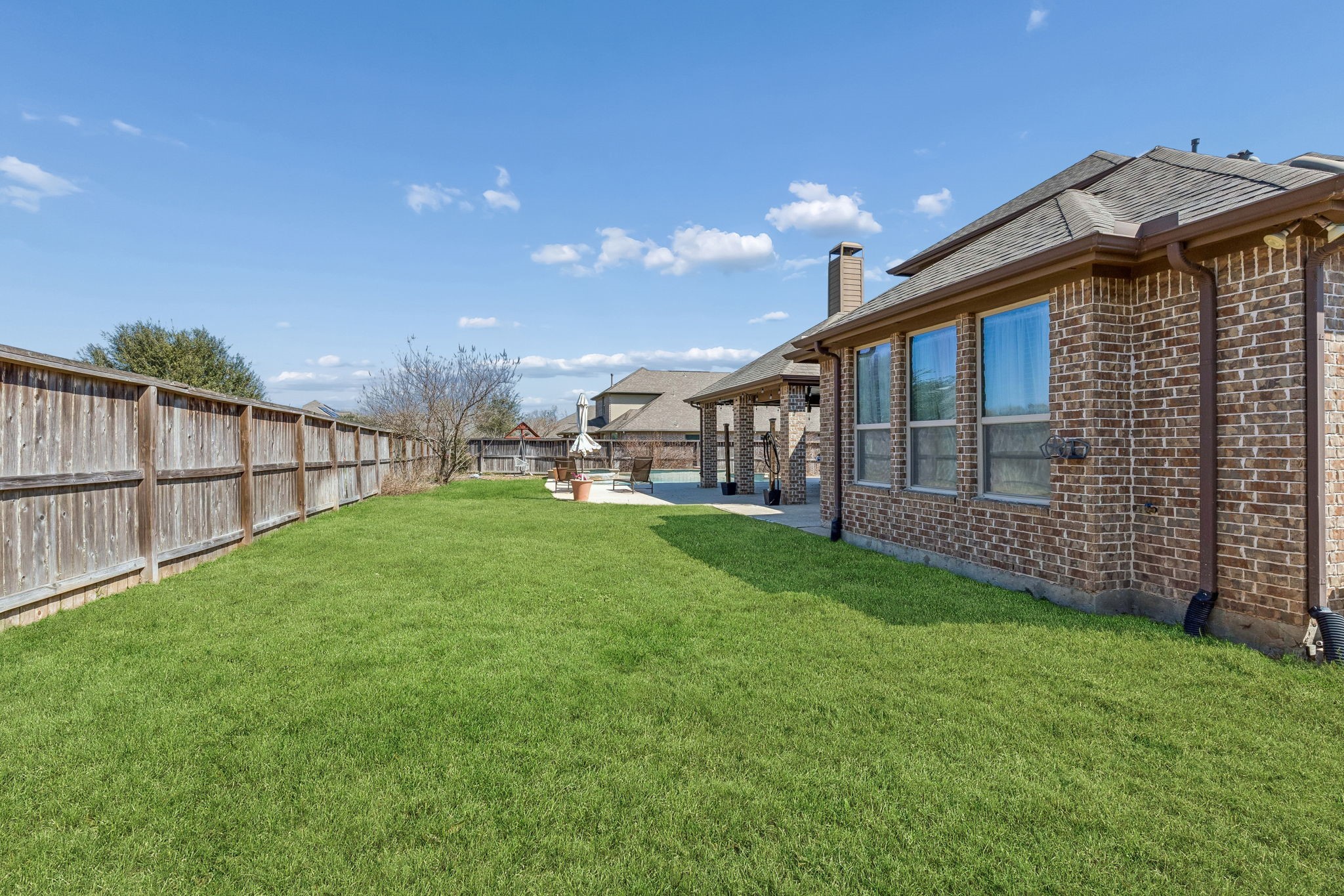 29918 Valley Terrace Drive Fulshear, TX 77406 - Photo 22 of 27 The expansive lush green lawn provides ample room for outdoor play or gardening. Fully fenced for privacy, this generous lot in Fullbrook at Fulshear Creek is the perfect canvas for your outdoor dreams.