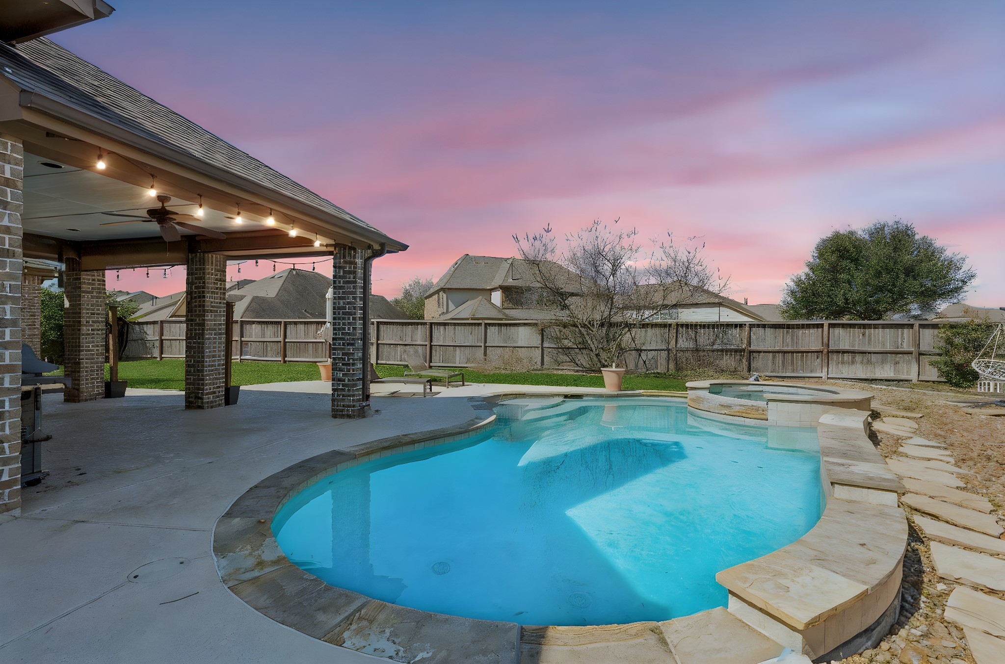 29918 Valley Terrace Drive Fulshear, TX 77406 - Photo 23 of 27 Enjoy resort-style evenings in your own backyard at 29918 Valley Terrace, where the illuminated pool and spa create the perfect setting for relaxing under the sunset or hosting unforgettable gatherings. ????