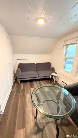 a room with a sink and wooden floor