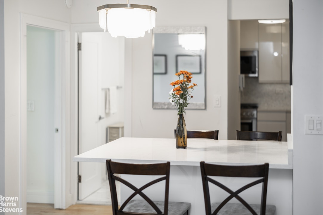 10 West 15th Street, Unit 1014 Manhattan, NY 10011 - Photo 15 of 19 a view of a dining room with a table and chairs
