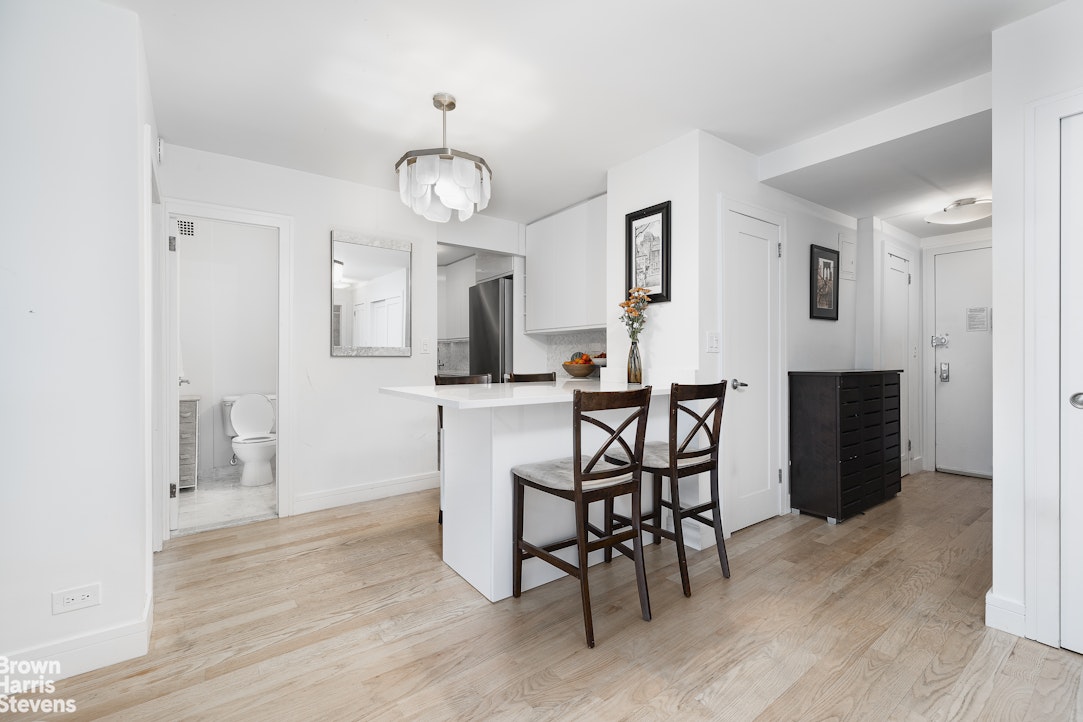 10 West 15th Street, Unit 1014 Manhattan, NY 10011 - Photo 6 of 19 a view of a dining room with furniture and wooden floor