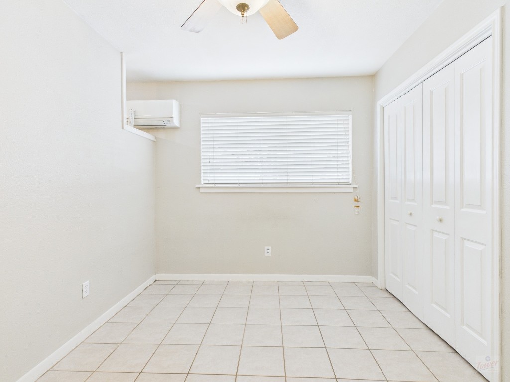 304 East 33rd Street, Unit 10 Austin, TX 78705 - Photo 15 of 28 an empty room with white walls and tiles