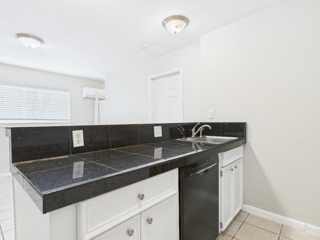 304 East 33rd Street, Unit 10 Austin, TX 78705 - Photo 10 of 28 a kitchen with a sink and cabinets