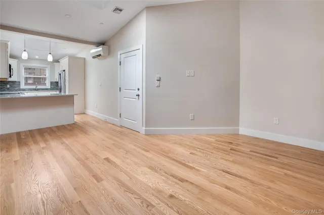 a view of a room with wooden floor and a sink