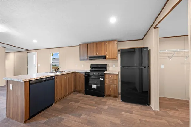 a kitchen with a refrigerator and a sink