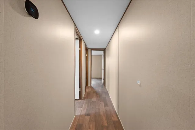 a view of hallway with a wooden floor