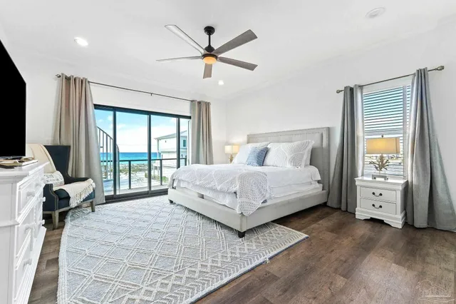 a bedroom with a bed and a large window