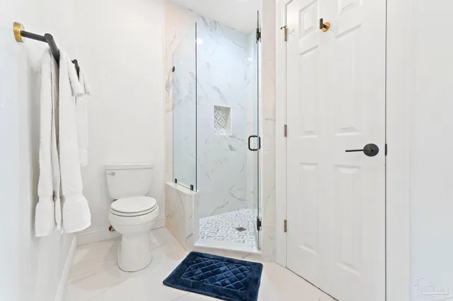 a bathroom with a shower a toilet and a shower