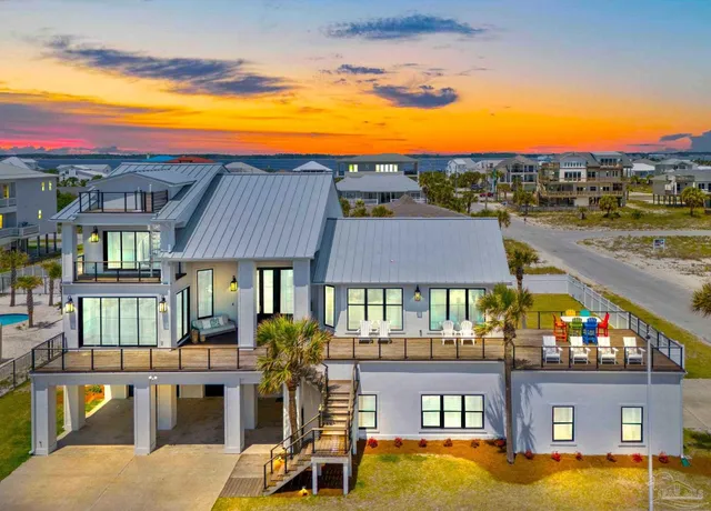 a view of a chairs and table in the patio and a swimming pool