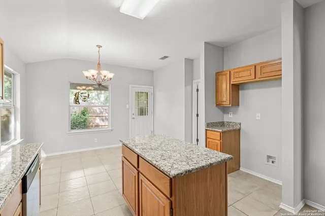 a kitchen with stainless steel appliances granite countertop a sink and a granite counter tops