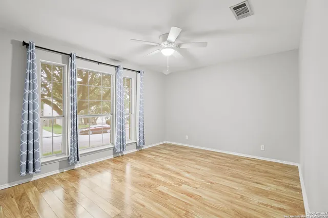 a view of an empty room with glass door