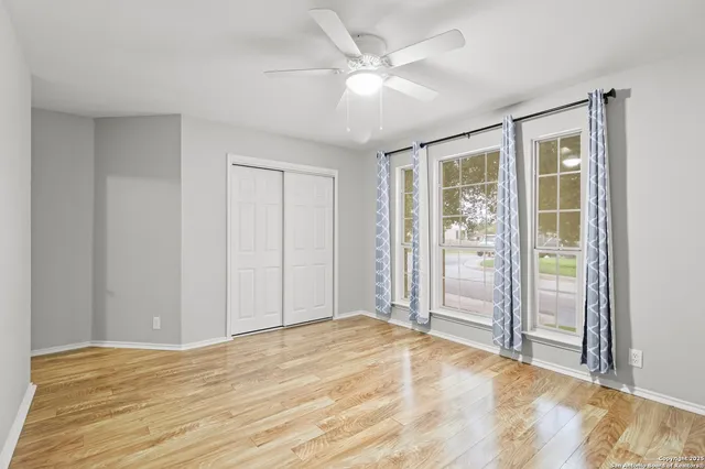 a view of empty room with wooden floor