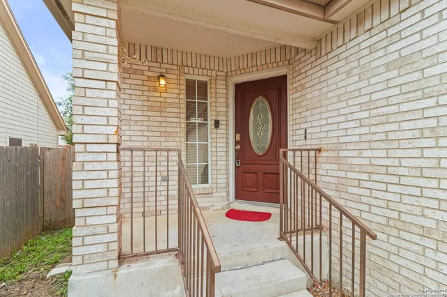 a front view of a house with wooden fence