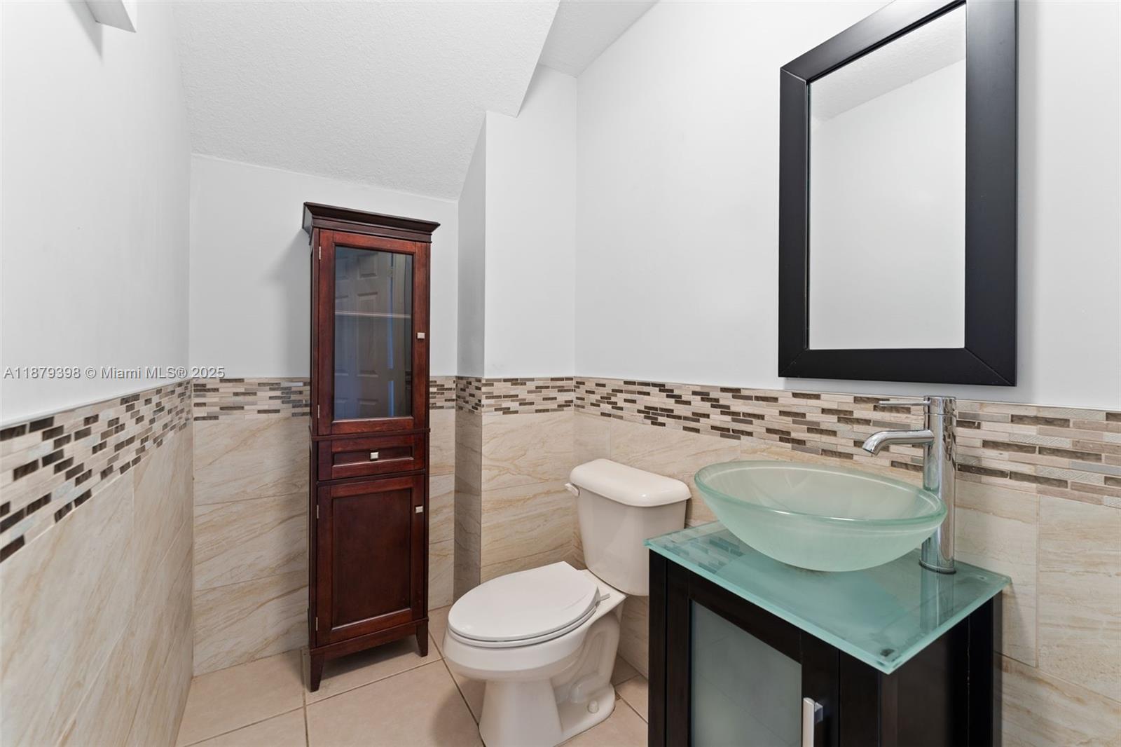 9035 Southwest 17th Court Miramar, FL 33025 - Photo 17 of 39 a bathroom with a granite countertop toilet sink and mirror