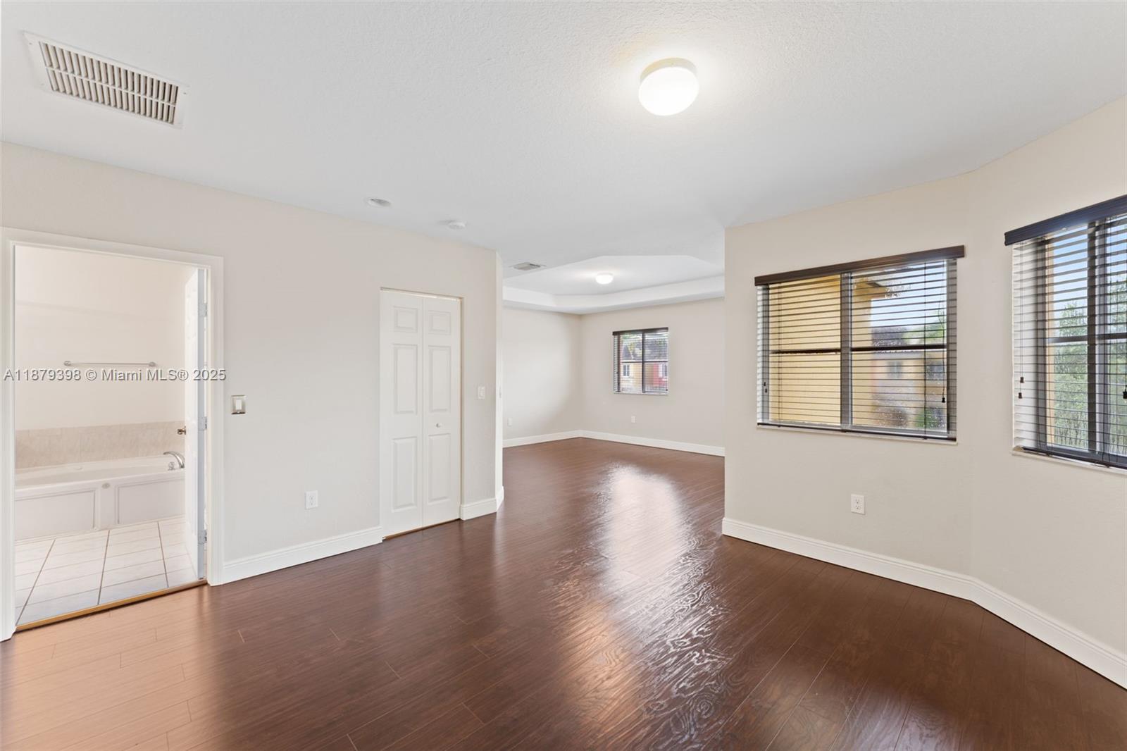 9035 Southwest 17th Court Miramar, FL 33025 - Photo 20 of 39 an empty room with wooden floor and windows