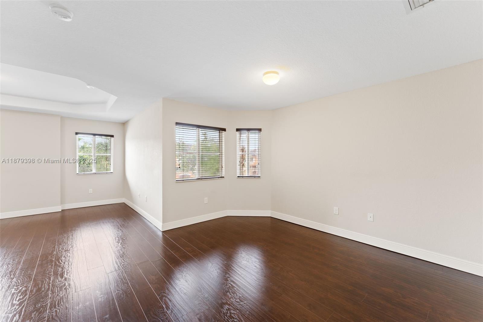 9035 Southwest 17th Court Miramar, FL 33025 - Photo 21 of 39 an empty room with wooden floor and windows