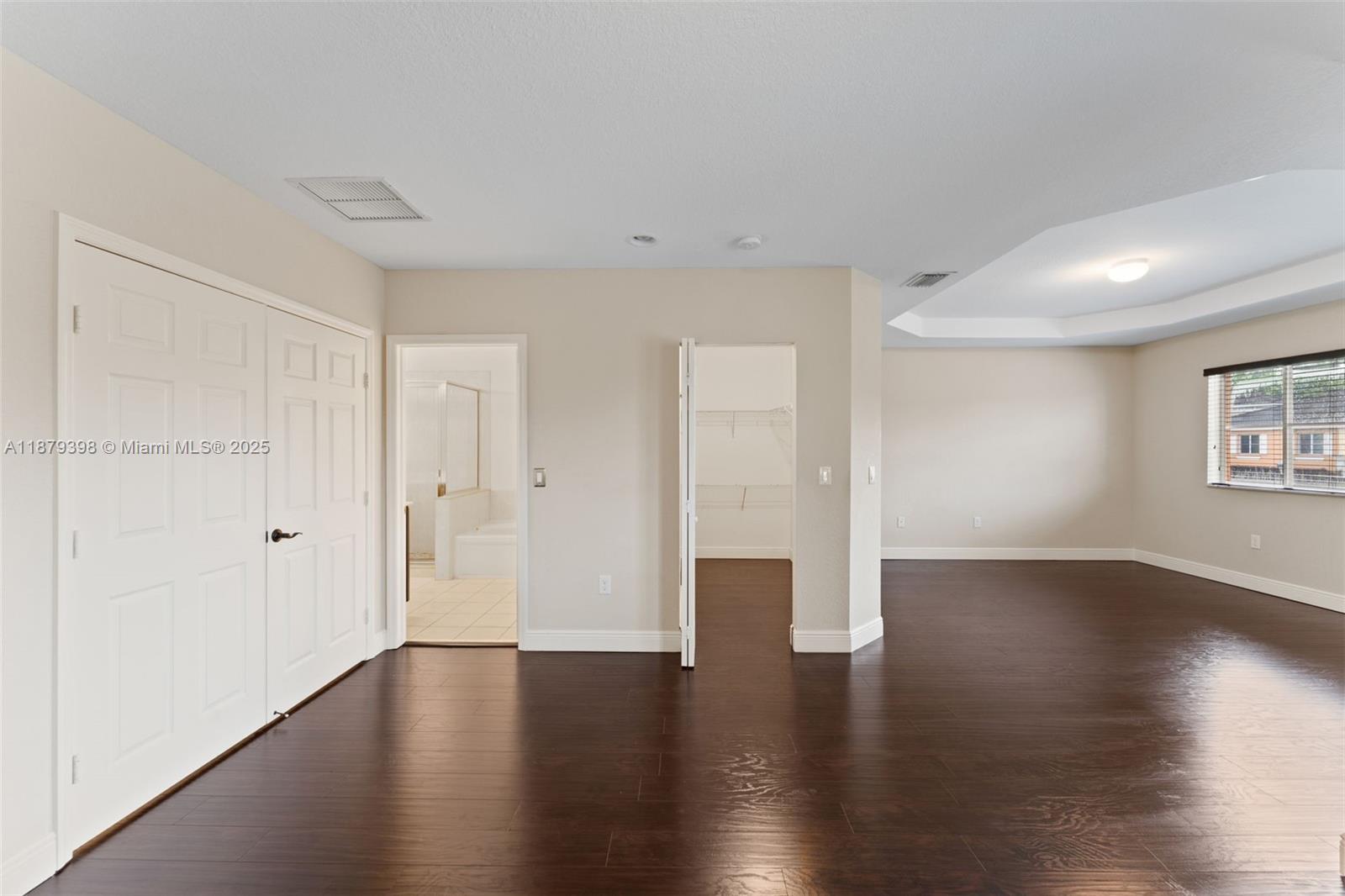 9035 Southwest 17th Court Miramar, FL 33025 - Photo 22 of 39 a view of an empty room with wooden floor and windows