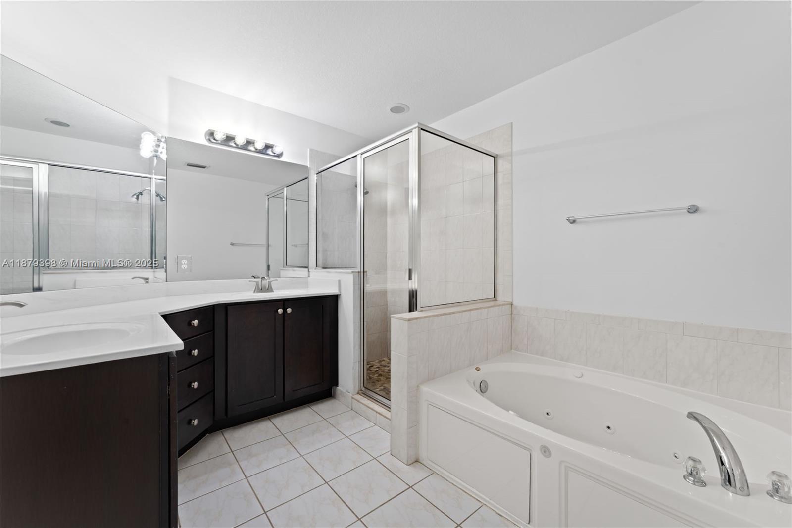 9035 Southwest 17th Court Miramar, FL 33025 - Photo 25 of 39 a bathroom with a double vanity sink mirror and bathtub