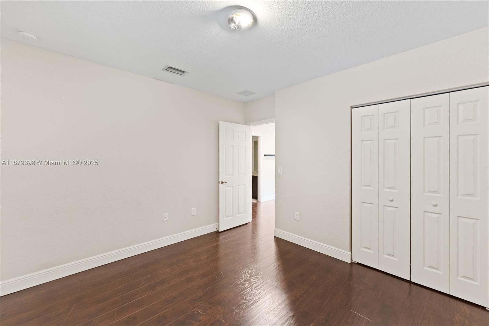 9035 Southwest 17th Court Miramar, FL 33025 - Photo 27 of 39 a view of an empty room with wooden floor