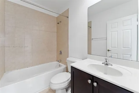 a bathroom with a sink toilet a mirror and shower