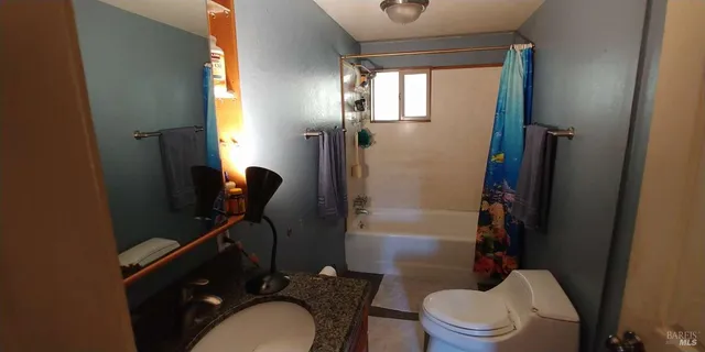 a bathroom with a sink vanity mirror and toilet