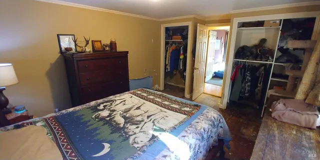 a bedroom with a bed and a mirror