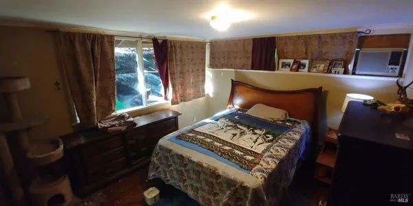 a bed sitting in a bedroom next to a window