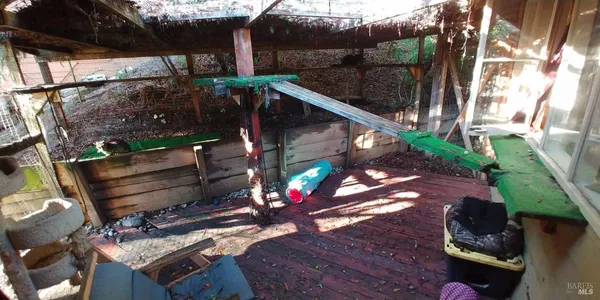 a view of balcony with wooden floor