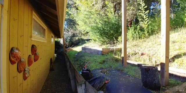 a backyard of a house with barbeque oven