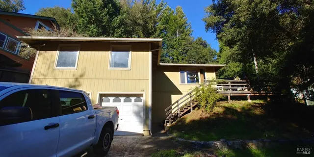 a view of a balcony with chairs and a fireplace