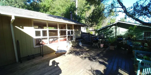 a view of a house with backyard and sitting area