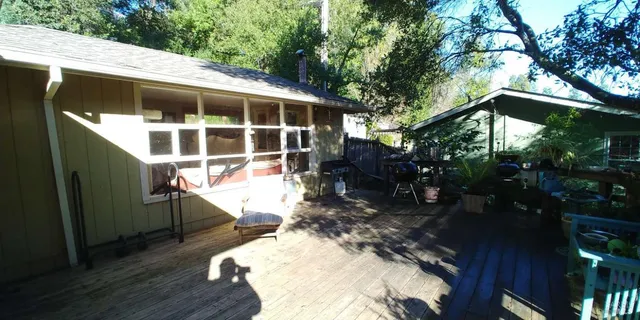 a view of a house with backyard and sitting area