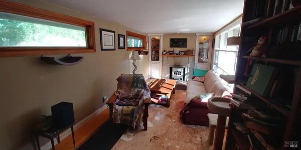 a view of a livingroom with furniture and a window